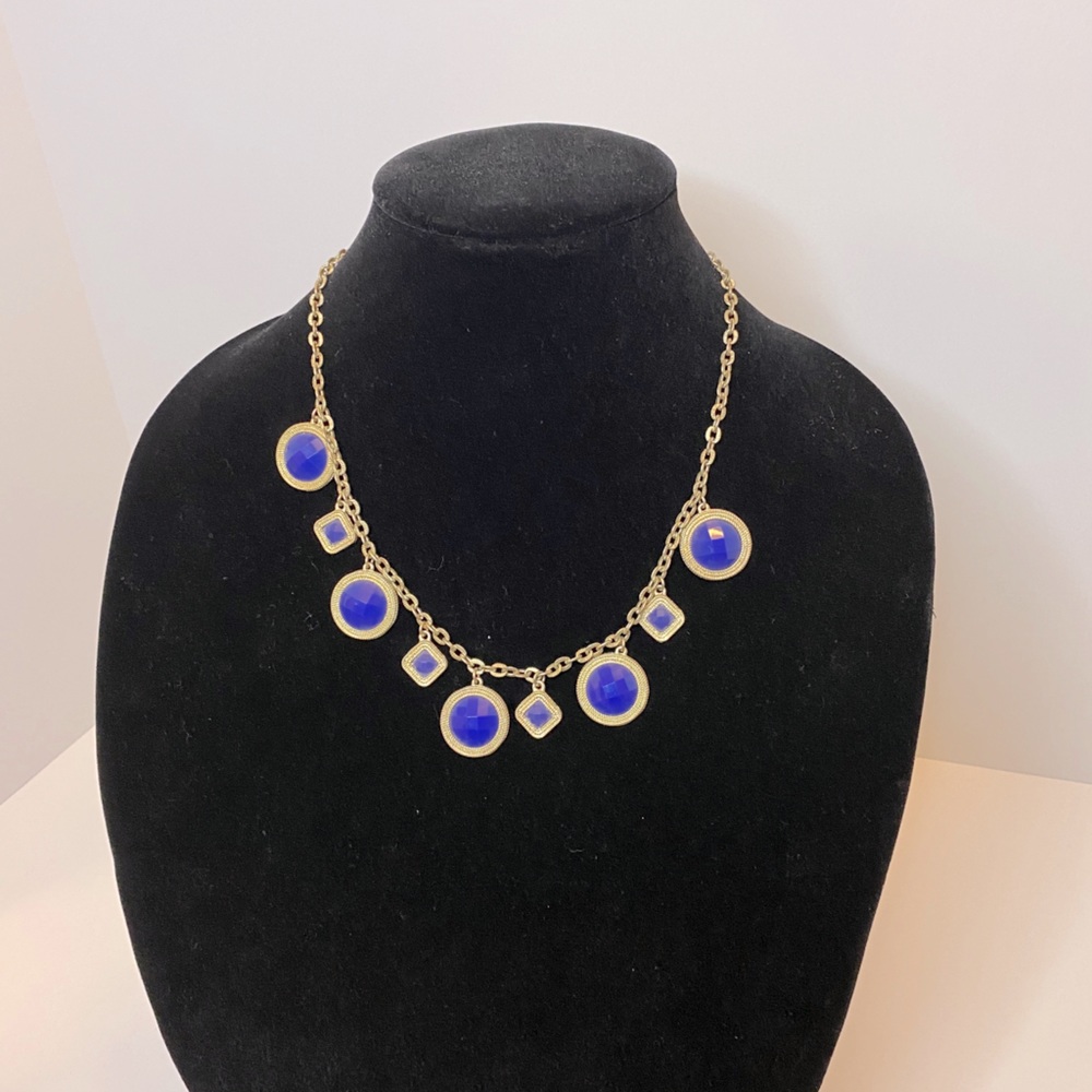 Gold necklace with bluish/purple stones.